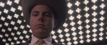 Movie still from “The Killer Inside Me” (2010), directed by Michael Winterbottom – A man wearing a cowboy hat in front of lights; Close Up shot, Low angle