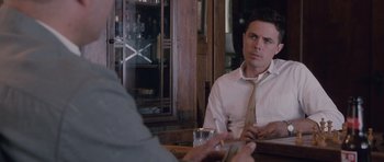 Movie still from “The Killer Inside Me” (2010), directed by Michael Winterbottom – A man sitting at a table in front of another man; Medium shot, Over the shoulder angle