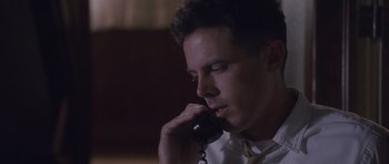 Movie still from “The Killer Inside Me” (2010), directed by Michael Winterbottom – A man talking on a phone while sitting down; Close Up shot, Low angle