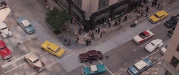 Movie still from “The Killer Inside Me” (2010), directed by Michael Winterbottom – An aerial view of a busy city street with cars and pedestrians; Extreme Wide shot, Overhead angle