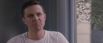 Movie still from “The Killer Inside Me” (2010), directed by Michael Winterbottom – A person wearing a white t - shirt; Close Up shot, Low angle