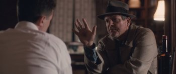 Movie still from “The Killer Inside Me” (2010), directed by Michael Winterbottom – An older man wearing a hat talking to a younger man; Close Up shot, Over the shoulder angle