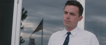Movie still from “The Killer Inside Me” (2010), directed by Michael Winterbottom – A person wearing a shirt and tie; Close Up shot, Low angle