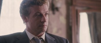 Movie still from “The Killer Inside Me” (2010), directed by Michael Winterbottom – A person wearing a suit and tie; Close Up shot, Over the shoulder angle