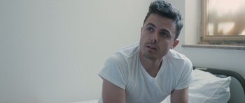 Movie still from “The Killer Inside Me” (2010), directed by Michael Winterbottom – A person sitting on a bed; Close Up shot, High angle