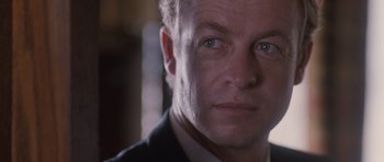 Movie still from “The Killer Inside Me” (2010), directed by Michael Winterbottom – A man's face in a dark room; Close Up shot, Low angle