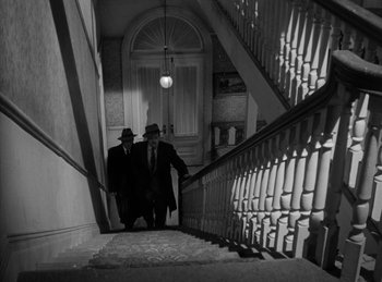 Movie still from “The Killers” (1946), directed by Robert Siodmak – A couple of men walking up a flight of stairs; Wide shot, Low angle