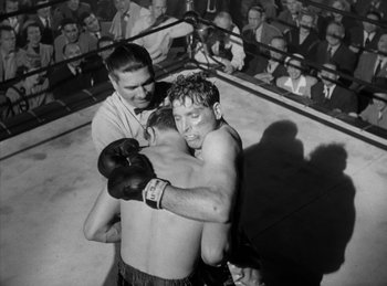 Movie still from “The Killers” (1946), directed by Robert Siodmak – Two men in a boxing ring with a crowd watching them; Medium shot, High angle