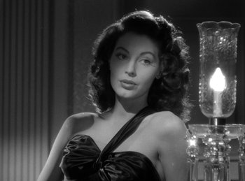 Movie still from “The Killers” (1946), directed by Robert Siodmak – A black and white photo of a woman in a black dress; Close Up shot, Low angle