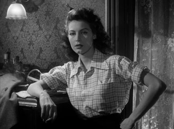 Movie still from “The Killers” (1946), directed by Robert Siodmak – A black - and - white photo of a woman sitting in front of a window; Medium shot, Low angle
