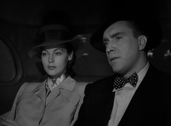 Movie still from “The Killers” (1946), directed by Robert Siodmak – A man and a woman sitting in the back of a car; Close Up shot, Low angle