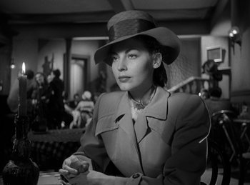 Movie still from “The Killers” (1946), directed by Robert Siodmak – A black and white photo of a woman wearing a hat; Close Up shot, Low angle