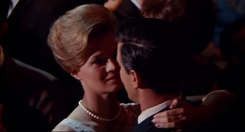 Movie still from “The Killers” (1964), directed by Don Siegel – A man and a woman in formal wear are kissing; Close Up shot, Low angle