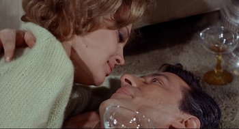 Movie still from “The Killers” (1964), directed by Don Siegel – A man and a woman laying on the ground; Close Up shot, Overhead angle