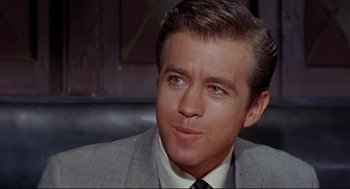 Movie still from “The Killers” (1964), directed by Don Siegel – A person wearing a suit and tie; Close Up shot, Over the shoulder angle