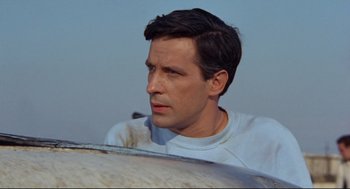 Movie still from “The Killers” (1964), directed by Don Siegel – A person with a surfboard; Close Up shot, Low angle