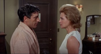 Movie still from “The Killers” (1964), directed by Don Siegel – A man and a woman standing next to each other; Medium shot, Low angle