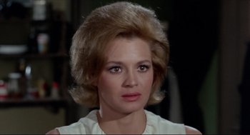 Movie still from “The Killers” (1964), directed by Don Siegel – A person wearing a white shirt; Close Up shot, Over the shoulder angle