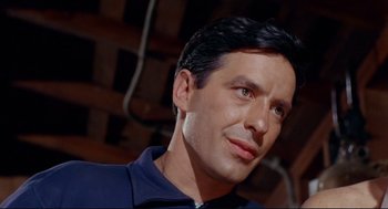 Movie still from “The Killers” (1964), directed by Don Siegel – A person wearing a blue shirt; Close Up shot, Low angle