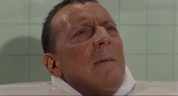 Movie still from “The Killers” (1964), directed by Don Siegel – A person with a towel on his head; Close Up shot, High angle