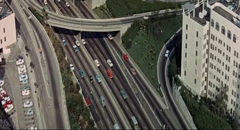 Movie still from “The Killers” (1964), directed by Don Siegel – An aerial view of a freeway with many cars on it; Extreme Wide shot, High angle