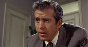 Movie still from “The Killers” (1964), directed by Don Siegel – A person wearing a suit and tie; Close Up shot, High angle