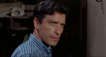 Movie still from “The Killers” (1964), directed by Don Siegel – A person wearing a striped shirt; Close Up shot, High angle