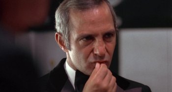 Movie still from “The Killing of a Chinese Bookie” (1976), directed by John Cassavetes – An older man wearing a suit and bow tie; Close Up shot, Low angle