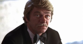 Movie still from “The Killing of a Chinese Bookie” (1976), directed by John Cassavetes – A person wearing a suit and tie; Close Up shot, Low angle