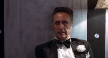 Movie still from “The Killing of a Chinese Bookie” (1976), directed by John Cassavetes – A person wearing a suit and bow tie; Close Up shot, Low angle