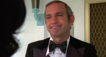 Movie still from “The Killing of a Chinese Bookie” (1976), directed by John Cassavetes – A person wearing a suit and bow tie; Close Up shot, Low angle