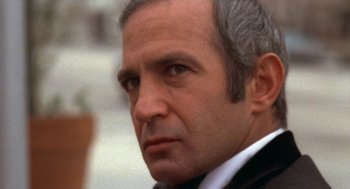 Movie still from “The Killing of a Chinese Bookie” (1976), directed by John Cassavetes – An older man in a suit and tie looking to his left; Close Up shot, Over the shoulder angle