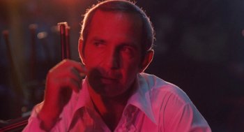 Movie still from “The Killing of a Chinese Bookie” (1976), directed by John Cassavetes – A person wearing a white shirt; Close Up shot, Low angle