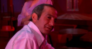 Movie still from “The Killing of a Chinese Bookie” (1976), directed by John Cassavetes – A person wearing a white shirt; Close Up shot, Low angle