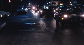 Movie still from “The Killing of a Chinese Bookie” (1976), directed by John Cassavetes – Cars are stopped at a red light at night; Wide shot, High angle