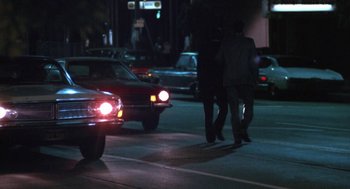 Movie still from “The Killing of a Chinese Bookie” (1976), directed by John Cassavetes – Two men walking down a street at night; Wide shot, Over the shoulder angle