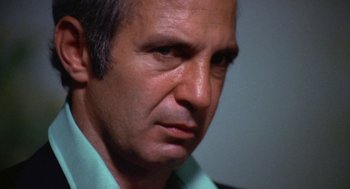 Movie still from “The Killing of a Chinese Bookie” (1976), directed by John Cassavetes – A man's face in a green shirt; Close Up shot, Low angle