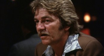 Movie still from “The Killing of a Chinese Bookie” (1976), directed by John Cassavetes – A person with a mustache; Close Up shot, Low angle