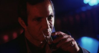Movie still from “The Killing of a Chinese Bookie” (1976), directed by John Cassavetes – A person holding a glass of wine; Close Up shot, Low angle