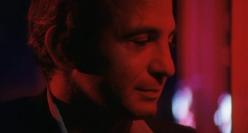 Movie still from “The Killing of a Chinese Bookie” (1976), directed by John Cassavetes – A man's face in a dark room; Close Up shot, Low angle