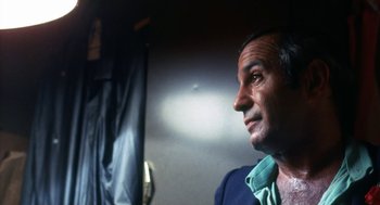 Movie still from “The Killing of a Chinese Bookie” (1976), directed by John Cassavetes – A person wearing a blue shirt; Close Up shot, Low angle