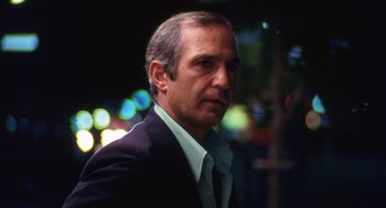 Movie still from “The Killing of a Chinese Bookie” (1976), directed by John Cassavetes – A person wearing a suit and tie; Close Up shot, Low angle