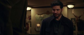 Movie still from “The Kindness of Strangers” (2019), directed by Lone Scherfig – A man standing in front of a mirror in a room; Close Up shot, Over the shoulder angle