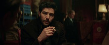 Movie still from “The Kindness of Strangers” (2019), directed by Lone Scherfig – A person holding a cigarette; Close Up shot, Over the shoulder angle