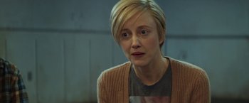 Movie still from “The Kindness of Strangers” (2019), directed by Lone Scherfig – A person with short blonde hair; Close Up shot, Over the shoulder angle