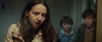 Movie still from “The Kindness of Strangers” (2019), directed by Lone Scherfig – A woman and a child in a dark room; Close Up shot, Over the shoulder angle