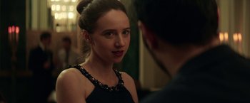 Movie still from “The Kindness of Strangers” (2019), directed by Lone Scherfig – A woman in a black dress talking to a man in a black suit; Close Up shot, Over the shoulder angle