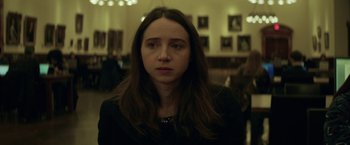 Movie still from “The Kindness of Strangers” (2019), directed by Lone Scherfig – A woman with long brown hair wearing a black shirt; Close Up shot, High angle