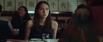 Movie still from “The Kindness of Strangers” (2019), directed by Lone Scherfig – A woman sitting at a table with a glass of wine; Close Up shot, Over the shoulder angle