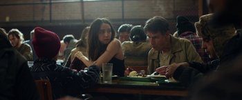 Movie still from “The Kindness of Strangers” (2019), directed by Lone Scherfig – A man and a woman sitting at a table eating food; Medium shot, Over the shoulder angle
